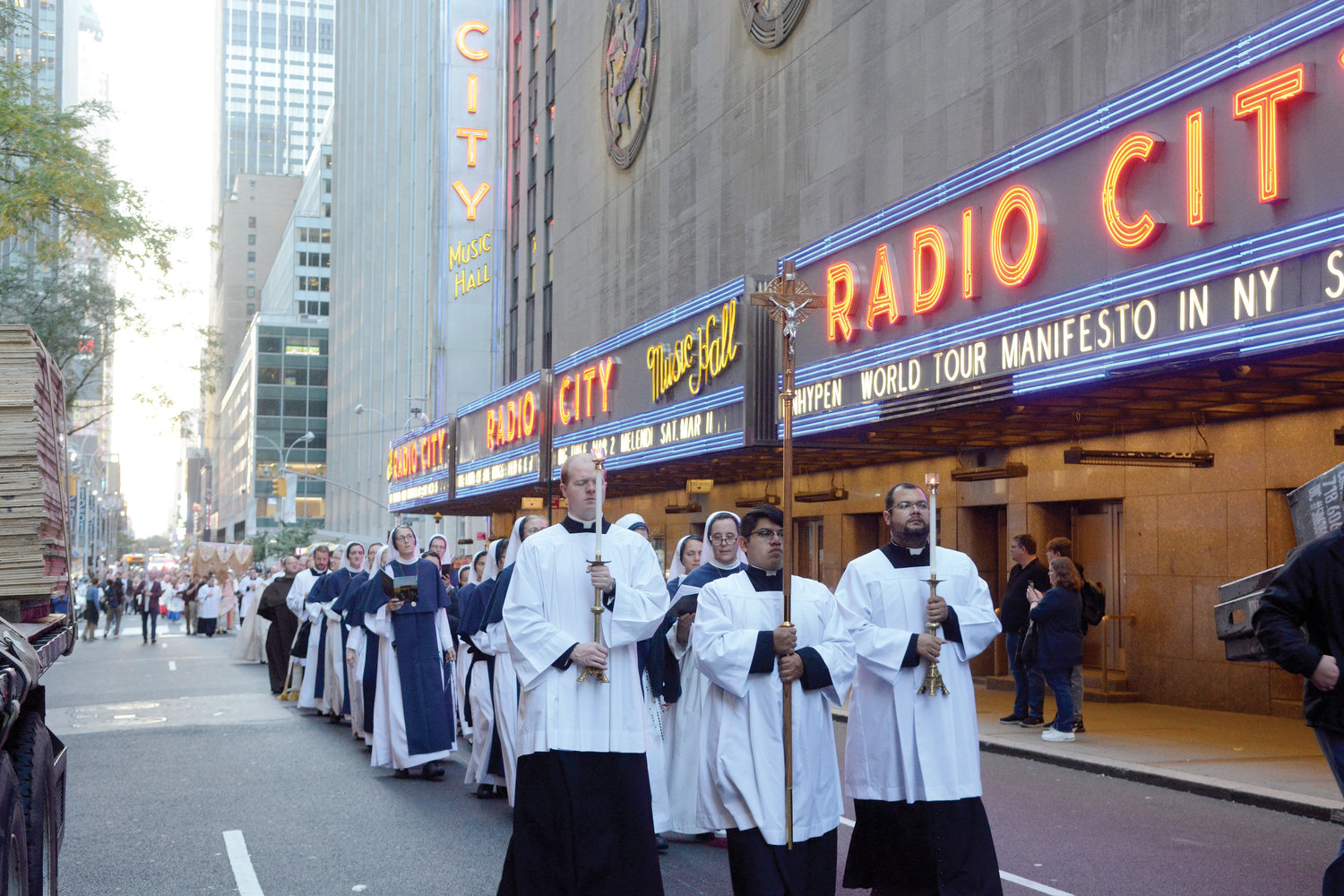 A Eucharistic procession in New York City on the afternoon of Oct. 11 walks past the iconic marquee of Radio City Music Hall en route to St. Patrick’s Cathedral, where Cardinal Dolan led Exposition of the Blessed Sacrament and Benediction.