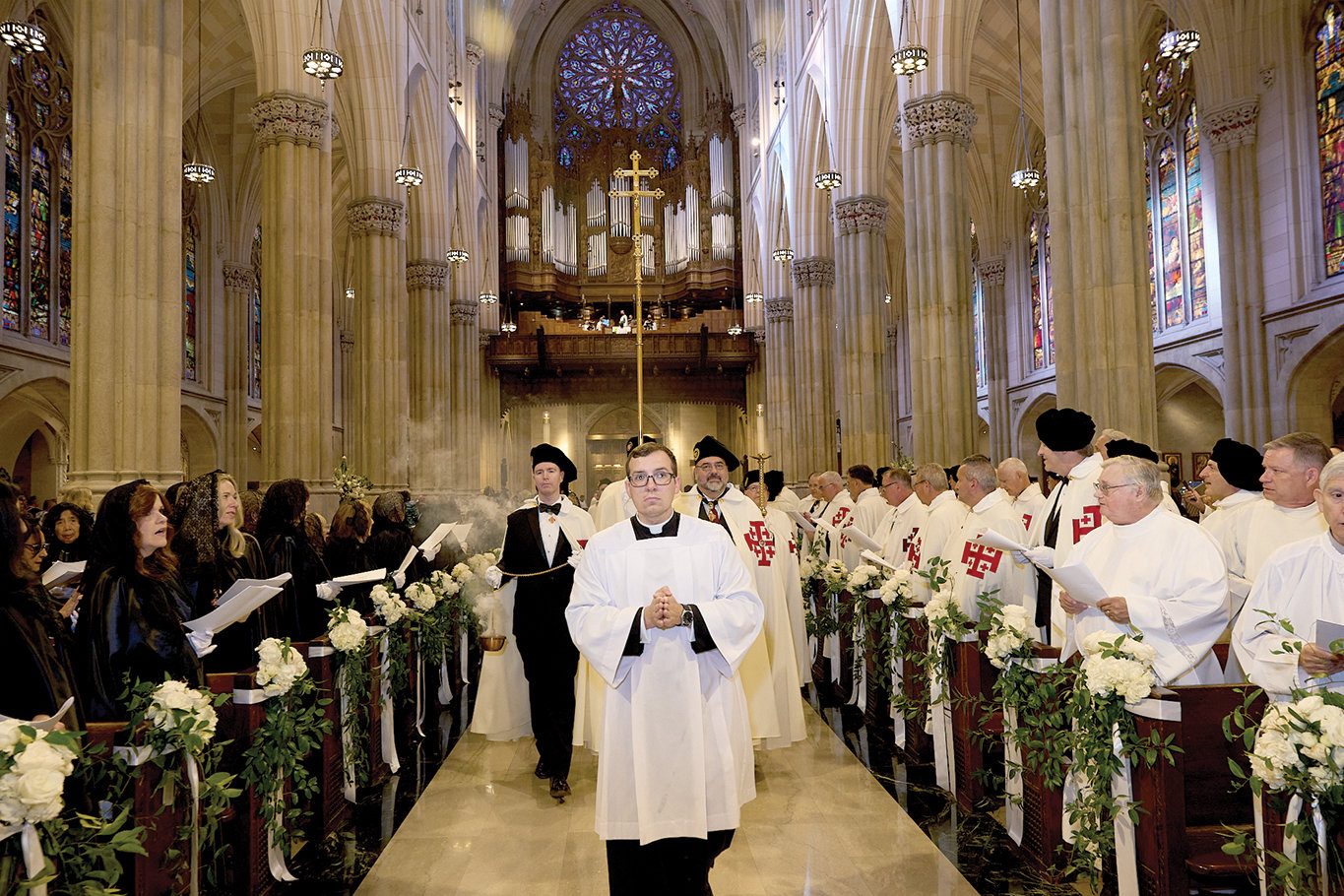 Dames and knights sing as they view the procession opening the Investiture Mass for the Order of the Holy Sepulchre at St. Patrick's Cathedral Oct. 15.