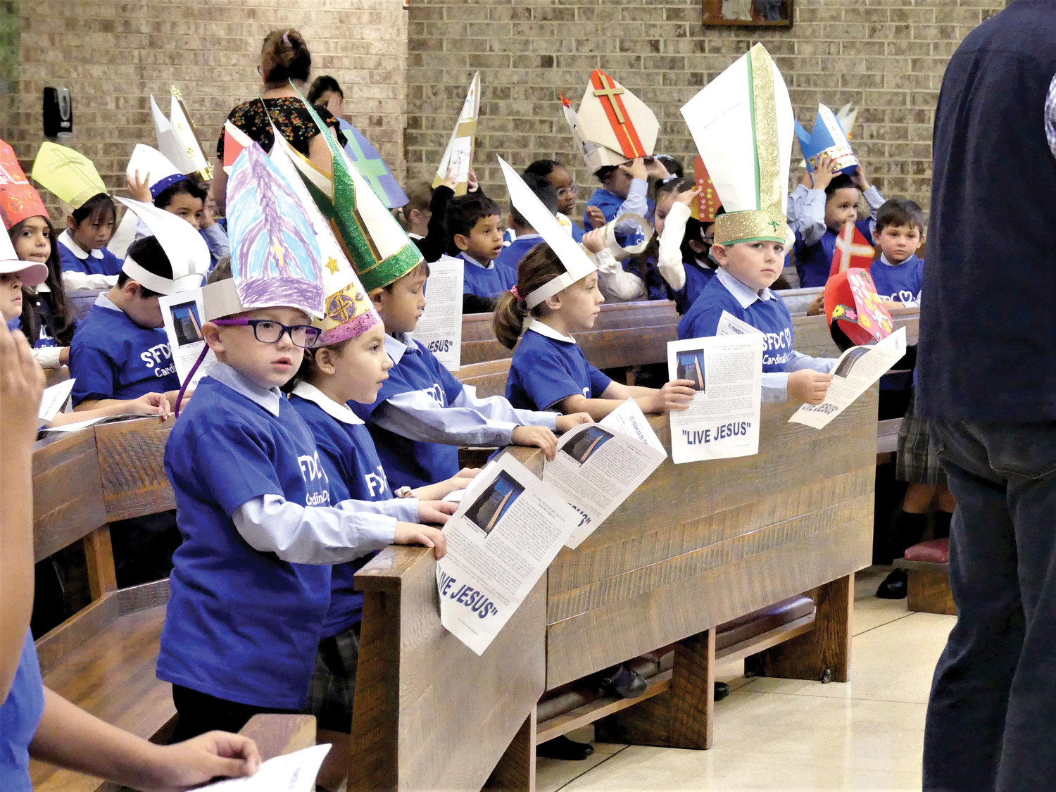 Students of St. Frances de Chantal School in the Bronx wear ecclesiastical headgear they fashioned themselves at a Mass Cardinal Dolan celebrated Oct. 13 at St. Frances de Chantal Church.