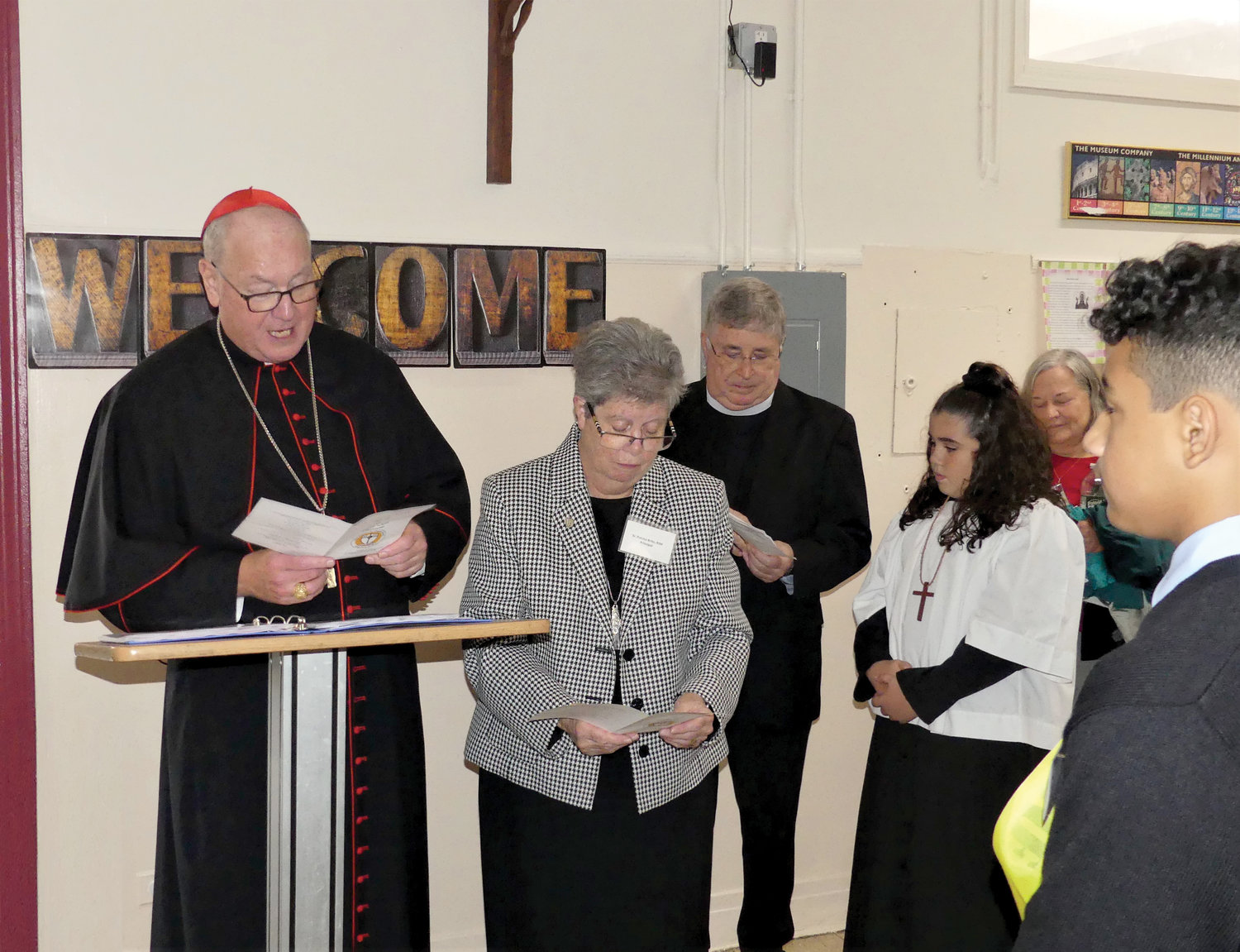 Cardinal Dolan blesses classrooms. Next to him are Sister Patricia Brito, R.J.M., principal, and Msgr. John Graham, pastor.