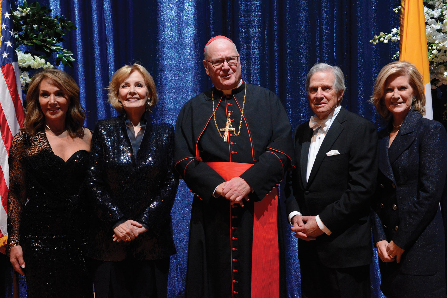 Cardinal Dolan greets honorees at the opening reception. From left are Rosanna Scotto, mistress of ceremonies; keynote speaker Peggy Noonan; Peter T. Grauer, the Happy Warrior honoree; and Mary Callaghan Erdoes, vice chair of the Alfred E. Smith Memorial Foundation.
