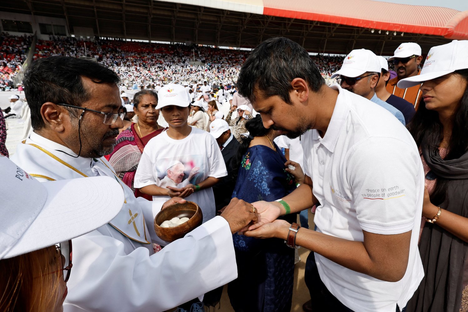A priest distributes Communion as Pope Francis celebrates Mass at Bahrain National Stadium in Awali, Bahrain, Nov. 5.