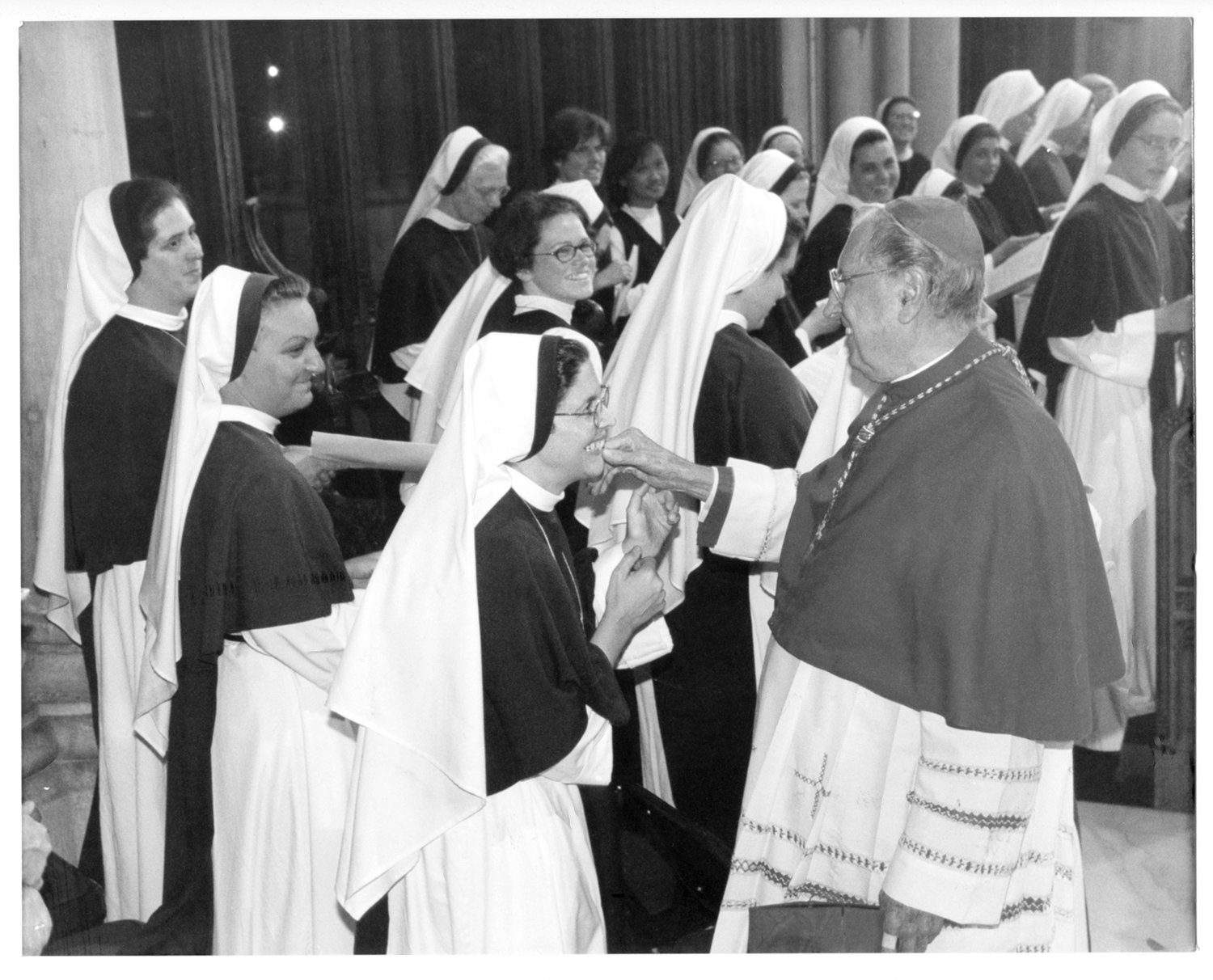 IN PERSON AND PRINT—Cardinal John O’Connor, above, greets jubilant Sisters of Life at St. Patrick’s Cathedral in September 1999. At left is the cardinal’s Nov. 2, 1989 From My Viewpoint column in Catholic New York in which the cardinal called for the foundation of the Sisters of Life.
