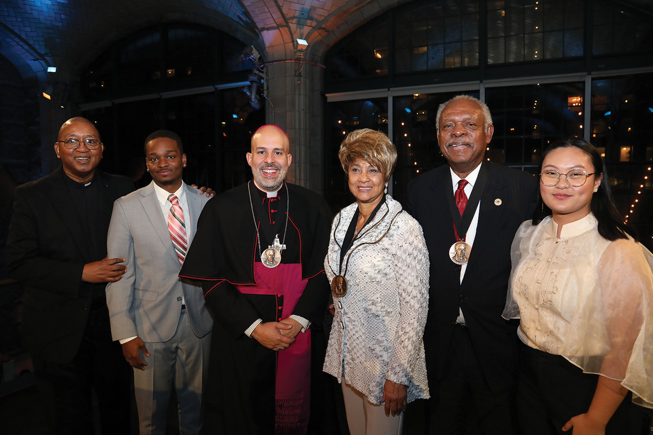 Brother Davis, left, joins emcee Keith West Guerrant, Bishop Espaillat, award recipients Nellie and Herbert Thomas Jr., and emcee Mary Lou DeJesus.