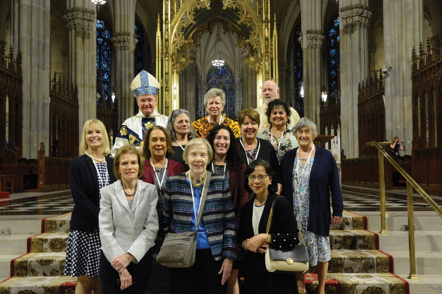 Bishop Whalen, Mrs. Buckley Teatum and Msgr. Sullivan gather with 10 of the 12 newly inducted Ladies of Charity.