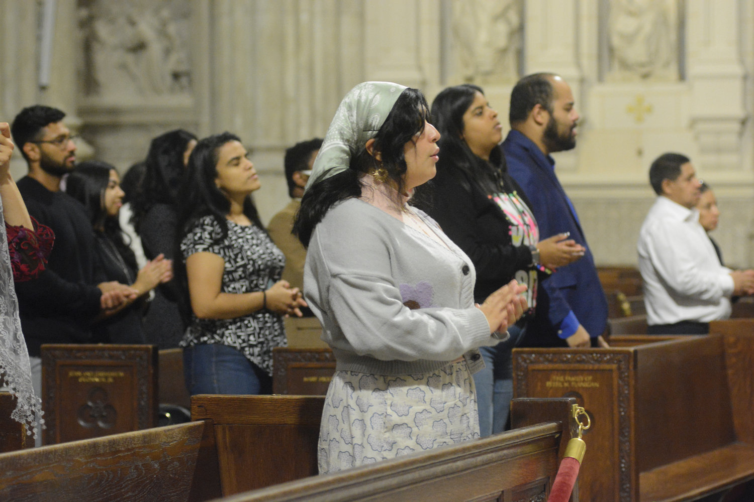 Members of the congregation prayerfully participate.